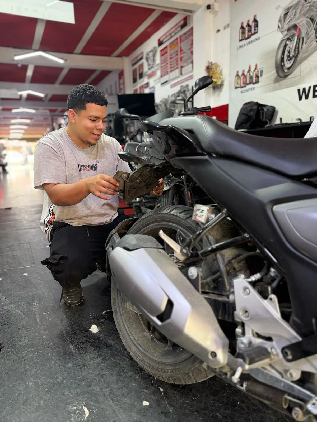 Técnico especializado trabajando en una motocicleta en Champions Motos